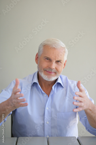Photo: Elderly man holding up his hands Elderly man holding up his hands