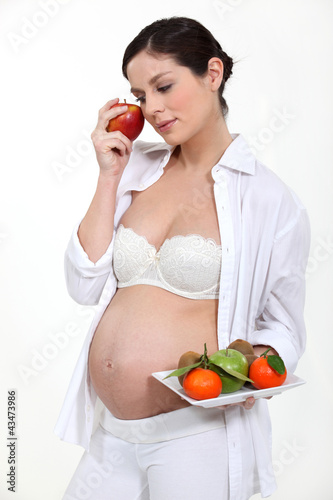 Photo: Pregnant woman with an apple Pregnant woman with an apple