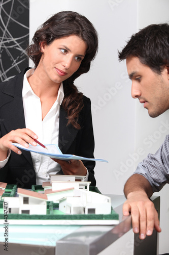 Photo: Estate agent and client discussing contracts Estate agent and client discussing contracts