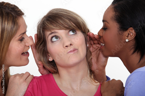 Photo: Doubtful woman surrounded by gossipers Doubtful woman surrounded by gossipers