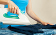 Woman ironing her clothes