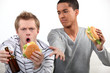 Friends eating hamburgers and watching a football game