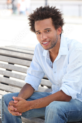 Photo: Man sat on park bench Man sat on park bench