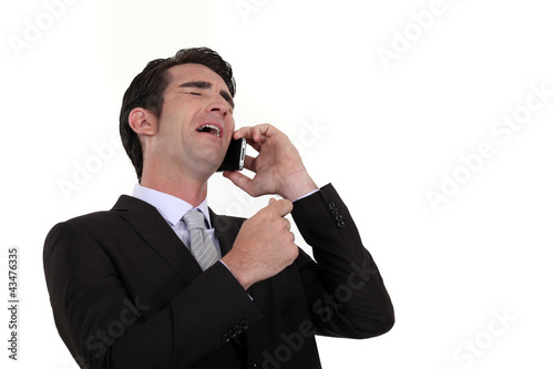 Foto: Businessman laughing during telephone call Businessman laughing during telephone call