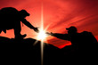 Silhouette of helping hand between two climber