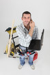 Handyman with a phone and laptop