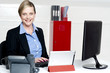 Photo: Cheerful female secretary typing document Cheerful female secretary typing document