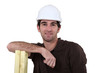 Man leaning on planks of wood