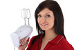 Foto: Woman holding up a mixer Woman holding up a mixer