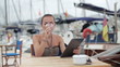 Video: Young woman with tablet computer sitting in marina Young woman with tablet computer sitting in marina
