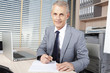 handsome businessman reads the agreement
