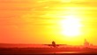 Passengers jet plane taking off in sunset