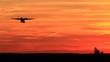 Passengers propellers plane taking off in sunset