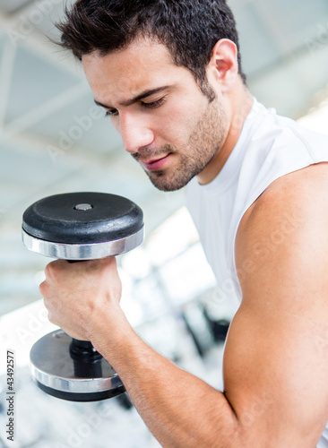 Photo: Man lifting weights Man lifting weights