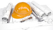 Rolls of architectural drawings and orange construction helmet