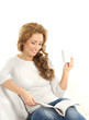 A young Caucasian woman relaxing on a white sofa