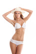 A young blond Caucasian woman posing in a white swimsuit