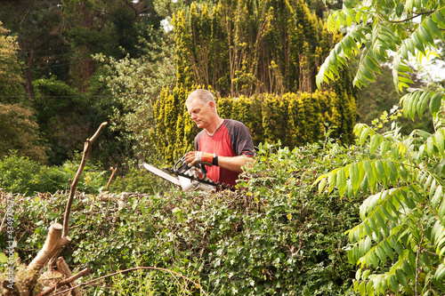 Photo: Man checking chainsaw Man checking chainsaw