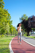 Beautiful  young girl jogging outdoor along trees path
