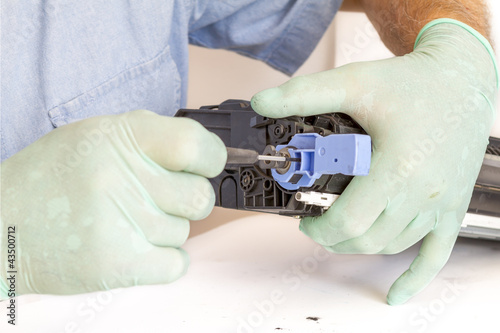 Photo: hands repairing toner cartridge hands repairing toner cartridge