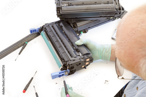 Photo: adult man working toner cartridge adult man working toner cartridge