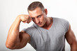 Photo: Muscular man flexing his biceps on white Muscular man flexing his biceps on white