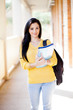 Foto: pretty female university student walking down school corridor pretty female university student walking down school corridor