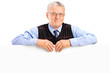 Mature man posing behing white panel