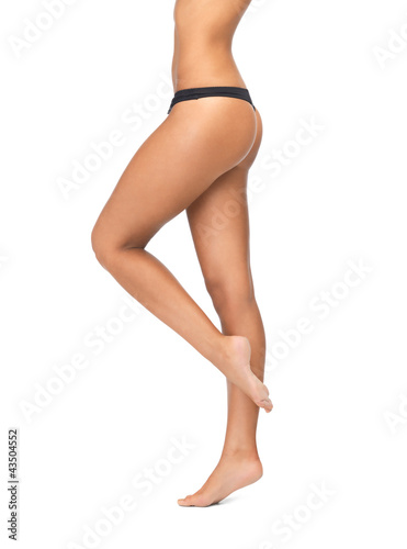 Photo: female legs in black bikini panties female legs in black bikini panties