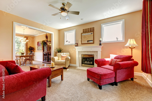 Photo: Beautiful peach and red liiving room interior with firepalce. Beautiful peach and red liiving room interior with firepalce.