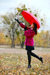 Photo: Young beautiful woman with umbrella in autumn park Young beautiful woman with umbrella in autumn park