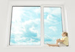 Child sitting on window, enjoying sunshine and dreaming. Big win