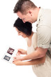 Photo: Happy pregnant couple with ultrasound pictures Happy pregnant couple with ultrasound pictures