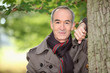 Retired man having a walk through the woods