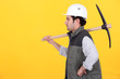 Profile of man with pick-axe