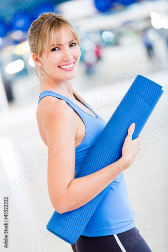 Photo: Woman with yoga mat Woman with yoga mat