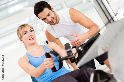 Photo: Gym woman with trainer Gym woman with trainer