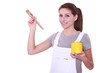 Woman holding paint pot and brush