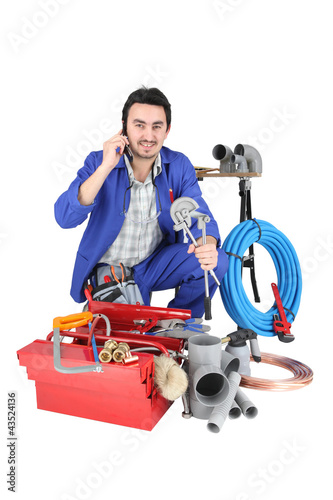 Photo: Plumber with a toolbox and cellphone Plumber with a toolbox and cellphone