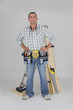 portrait of carpenter fully equipped standing with arms akimbo