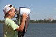 child (boy) is looking through binoculars