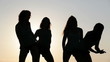 Video: Four slim women dancing over sun on the beach Four slim women dancing over sun on the beach