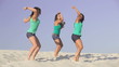 Video: Team of pretty energetic girls dancing on the sand together Team of pretty energetic girls dancing on the sand together