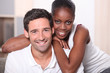 Landscape portrait of a mixed race couple indoors