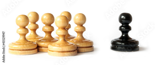 Photo: Racism between black and white pawns isolated Racism between black and white pawns isolated