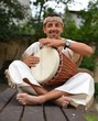 Photo: Portrait of young latino percusionist playing african drums Portrait of young latino percusionist playing african drums