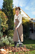 Woman raking leaves in  the garden