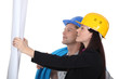 Architect and builder looking at plans