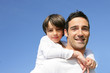 Photo: little boy on his father's back little boy on his father's back