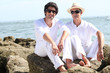 father and son posing at sea resort